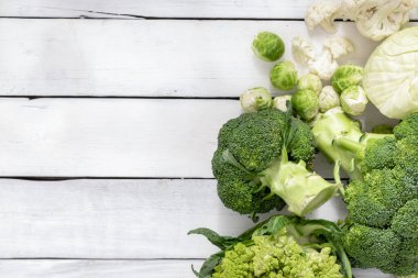 Set of different cabbage on wooden table with copy space top view