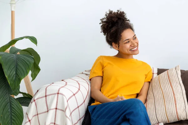 Beautiful Carefree African American Woman Relax Sitting Sofa Home Looking — стоковое фото