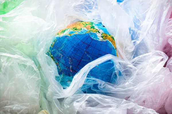 Save our planet or World Environment Day concept Earth in a plastics bags