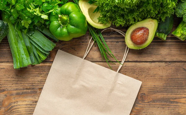 Paper Shopping Bag Green Vegetables Wooden Background Buying Delivering Food — Fotografia de Stock