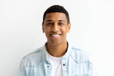 Portrait of happy smiling mam freelancer looking at the camera and smiles friendly. Young African American male student smile joyfully standing on a white background