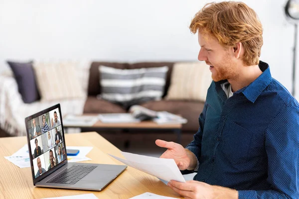 Virtual conference, meeting or briefing concept. Young businessman, business owner using laptop app for communicating with employees or partners, discussing something