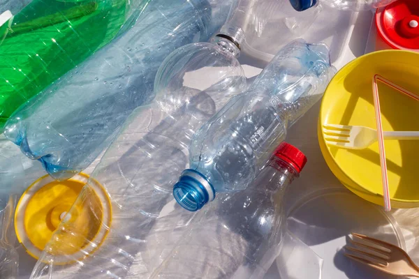 Reuse garbage, recycle, plastic free. Multi-colored plastic trash on a white background. Ecology concept. No plastic collection poster banner concept template