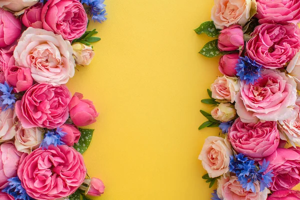 Composition of beautiful flowers, on yellow background. Flowers spring or summer frame. Colorful flowers festive background. Floral concept.