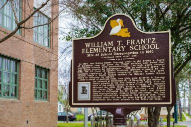NEW ORLEANS, LA, USA - MARCH 16, 2022: Historic marker at William T. Frantz Elementary School commemorating the desegregation of New Orleans public schools in 1960 clipart