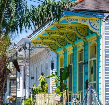 NEW ORLEANS, LA, USA - APRIL 9, 2022: Row of colorful historic shotgun houses in Faubourg St. John neighborhood