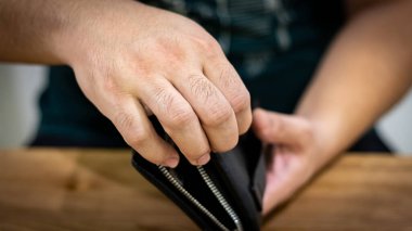 Black leather wallet with smart watch on the wooden table 
