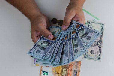 man hand holding a bunch of dollars on white background