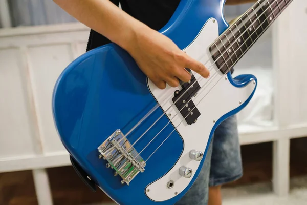 Close up of a bass played by a child.