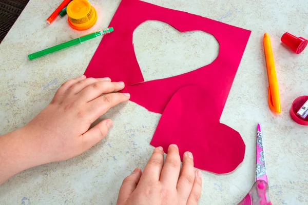St. Valentines day theme. Crafts concept. Child makes art art project . High quality photo