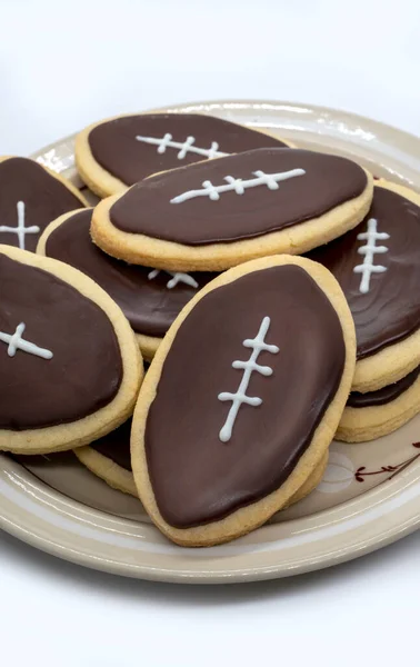 Football shape cookies on plate. Home made cookies concept. American sport concept. Super Bowl party cookies. High quality photo