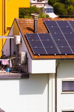Solar panels on pitched tiled roof, Rimini, Italy. High quality photo