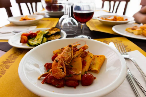 Cannelloni with red shrimp sauce and wine, Rimini, Italy. High quality photo