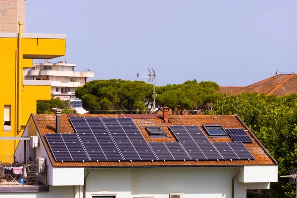 Solar panels on pitched tiled roof, Rimini, Italy. High quality photo