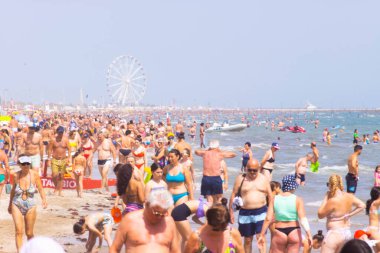 Beach with bathers in summer. Rimini, Italy, editorial image. High quality photo