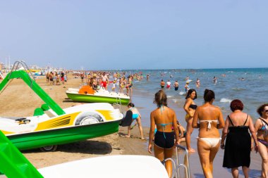 Beach with bathers in summer. Rimini, Italy, editorial image. High quality photo