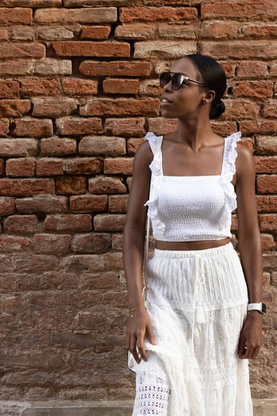 Portrait of African American woman dressed in white getting to know Europe, Ferrara. Italy. High quality photo