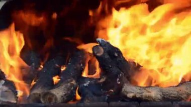 fire burns in a brazier with firewood. Kindling the grill for cooking meat. Close up. Background