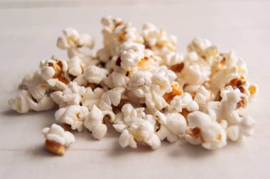 Close up of heap popcorn on a white background. Concept of yummy food.