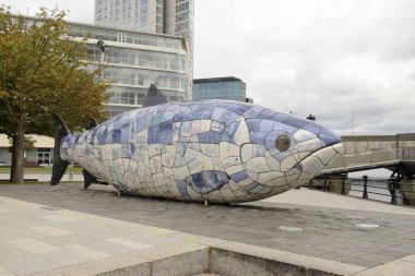the salmon of knowledge, also known as the big fish, is cladded with ceramic tiles displaying text and images relating to the history of Belfast.