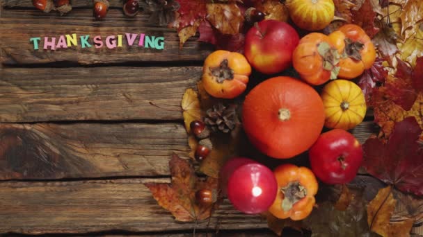 Letters thanksgiving with autumn vegetables harvest foliage wooden background — Stock Video