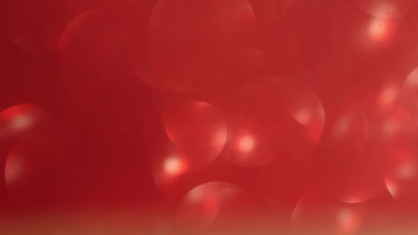 赤い焦点を当てたボケライトを背景にクリスマス、バレンタインデーのコンセプトを移動 — ストック動画