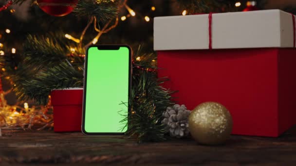 Boże Narodzenie tło czerwony prezent pudełko smartfon gadżet zielony ekran migające światła — Wideo stockowe