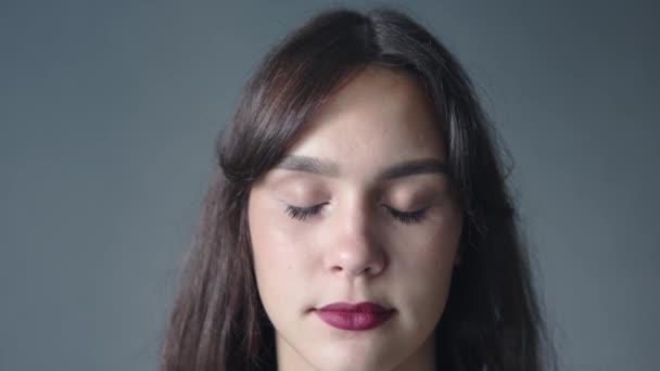 Closeup portrait young brunette female looking at camera brown eyes red lipstick — Stock Video