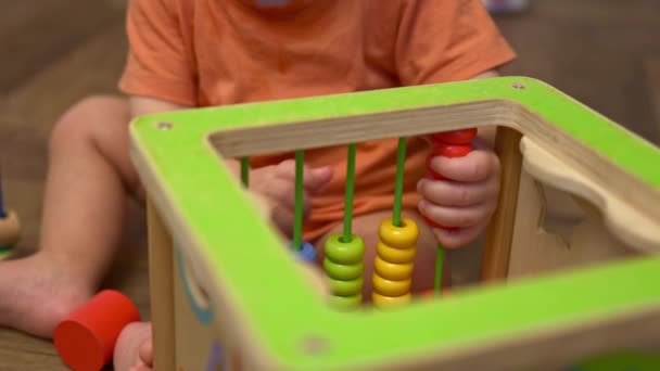 Winzige Baby Kind Kleinkind Hände spielen bunte hölzerne Abakus-Spielzeug — Stockvideo