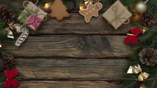 Christmas decorations on wooden background, ornaments, lights, fir tree brunches — Stock Video