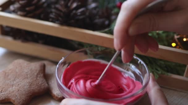 Making white red glaze sugar icing for biscuits cookies decorations mixing color — Stock Video
