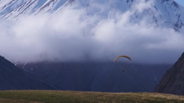 Nubes, montañas y un parapente — Vídeo de stock
