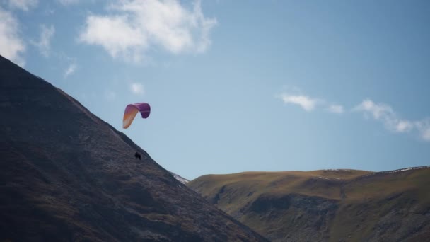 Paragliding naast de berghelling — Stockvideo