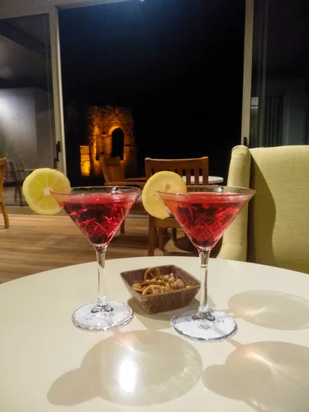 a glass of martini in a row on the background of the bar of the restaurant.