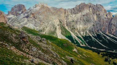Rocky mountains in the Dolomites. Catinaccio mountain group in Italy. Via ferrata in summer in Italy. Green valley in the Italian mountains. Beautiful panorama in the mountains