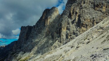 Rocky mountains in the Dolomites. Catinaccio mountain group in Italy. Via ferrata in summer in Italy. Green valley in the Italian mountains. Beautiful panorama in the mountains