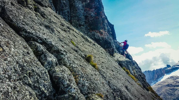 A man climbing in the mountains. Climbing on via ferratas. Climbing in the Dolomites over the precipice.