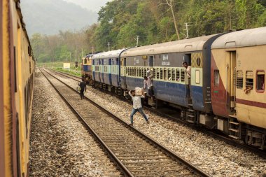 5 Nisan 2022, Shevok, Batı Bengal, Hindistan: Hint Demiryolu 'ndan iki tren Shevok İstasyonu' na vardı ve çok az yolcu raylara indi. Arkaplanda seçici odaklı dağlar.