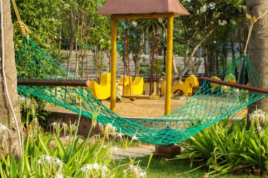 A hammock between two palm tree at the bank of river Ganges. Selective focus.