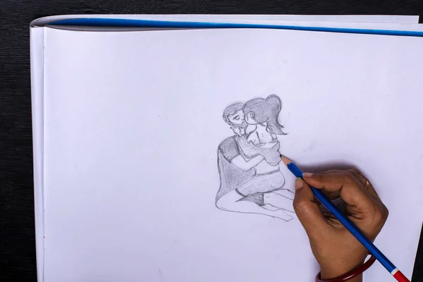 A female doing a pencil sketch painting on a white paper with pencil.