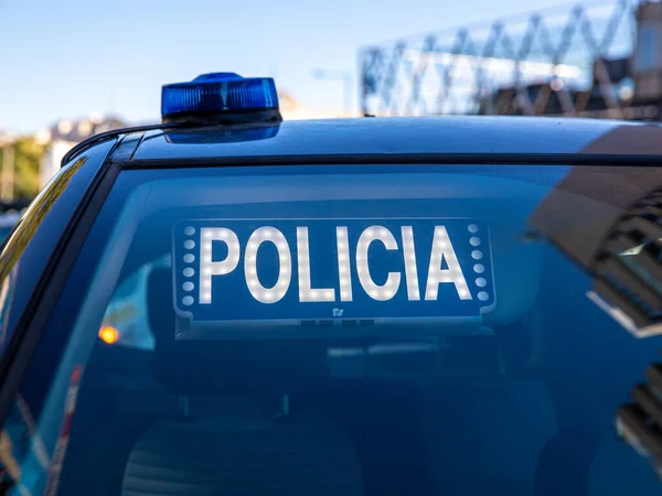 Polis arabasının tepesindeki mavi ışıklar. Arka plan bulanık. Işıklar da bokeh etkisi yapıyor.