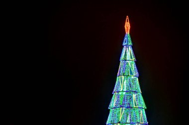 Christmas in Puerta del Sol, in the city of Madrid with lighting and typical decoration, with the clock and christmas tree