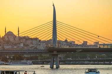 İstanbul 'da Haliç metro köprüsünün İstanbul nehri üzerindeki manzarası, açık bir yaz gününde gün batımında