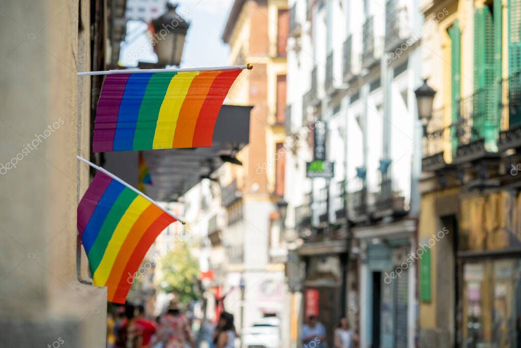 Multi-colored flags for gay pride and LGBT+ during gay pride week in the city of Madrid