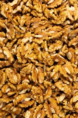 Peeled fresh golden walnuts close up in bulk top view for background