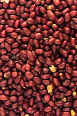 Peeled fresh golden peanuts nuts close up in bulk top view for background