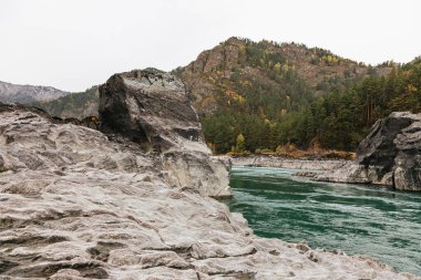 Mountain river surrounded by high rocks in Altai in autumn