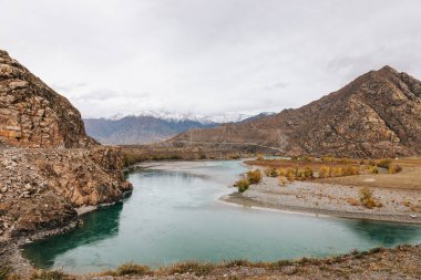 Mountain river surrounded by high rocks in Altai in autumn