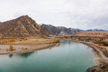 Mountain river surrounded by high rocks in Altai in autumn