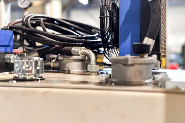 Atölyedeki hidrolik petrol istasyonuna bağlı hortumlar.